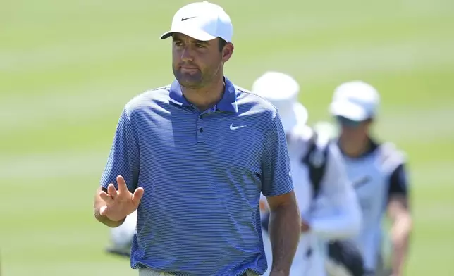 Scottie Scheffler waves after sinking a putt on the sixth green during the final round of the CJ Cup Byron Nelson golf tournament in McKinney, Texas, Sunday, May 4, 2025. (AP Photo/LM Otero)