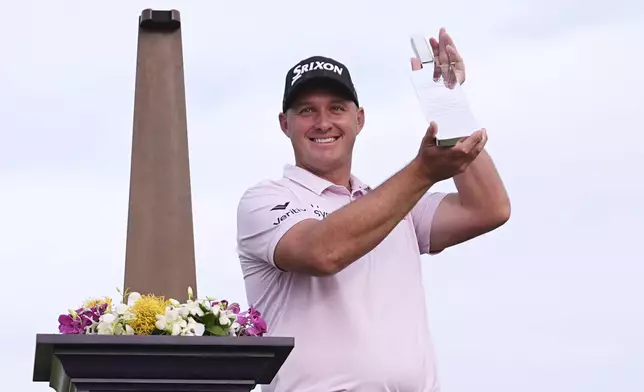 Sepp Straka, of Austria, poses with the trophy after winning the Truist Championship golf tournament at the Philadelphia Cricket Club, Sunday, May 11, 2025, in Flourtown. (AP Photo/Matt Rourke)