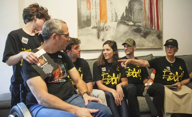 Relatives and friends of Israeli-American soldier Edan Alexander gather to watch the TV broadcast of his release from Hamas captivity in Gaza, in Tel Aviv, Monday, May 12, 2025. Alexander was abducted during the Hamas-led attack on his base on October 7, 2023. (AP Photo/Ohad Zwigenberg)