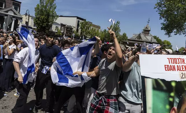 People gathered in Huyler Park celebrate the release of American hostage Edan Alexander from Hamas on Monday, May 12, 2025, in Tenafly, N.J. (AP Photo/Stefan Jeremiah)