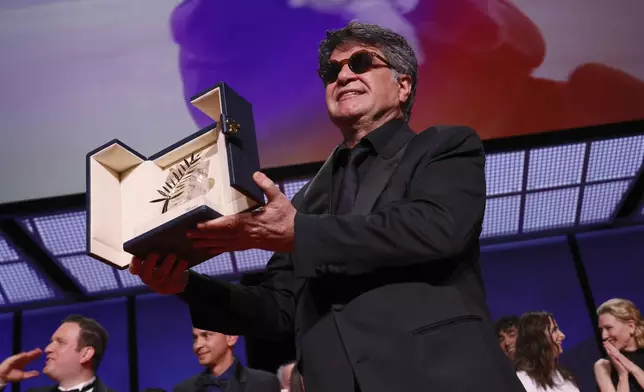 Director Jafar Panahi, accepts the Palme d'Or for the film 'It Was Just an Accident', during the awards ceremony of the 78th international film festival, Cannes, southern France, Saturday, May 24, 2025. (Photo by Joel C Ryan/Invision/AP)
