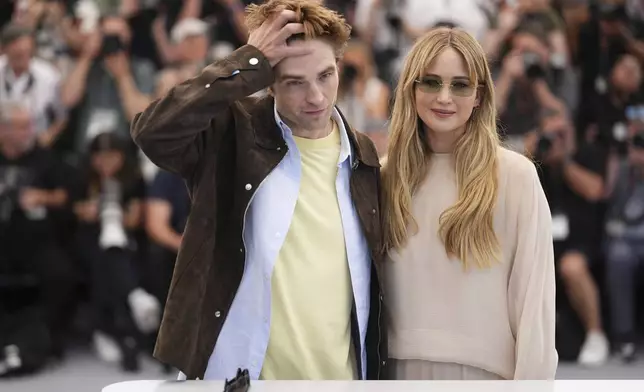 Robert Pattinson, left, and Jennifer Lawrence pose for photographers at the photo call for the film 'Die, My Love' at the 78th international film festival, Cannes, southern France, Sunday, May 18, 2025. (Photo by Scott A Garfitt/Invision/AP)