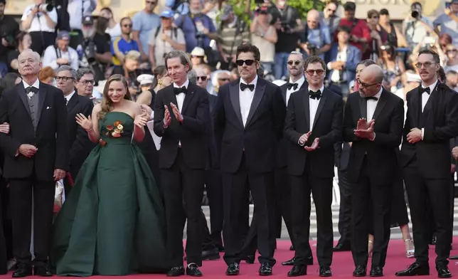 Bill Murray, from left, Mia Threapleton, director Wes Anderson, Benicio del Toro, Michael Cera, Jeffrey Wright and Benedict Cumberbatch pose for photographers upon arrival at the premiere of the film 'The Phoenician Scheme' at the 78th international film festival, Cannes, southern France, Sunday, May 18, 2025. (AP Photo/Natacha Pisarenko)