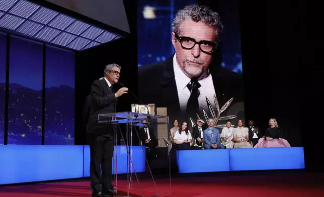 Director Kleber Mendonca Filho, accepts the award for best director for 'The Secret Agent', during the awards ceremony of the 78th international film festival, Cannes, southern France, Saturday, May 24, 2025. (Photo by Joel C Ryan/Invision/AP)
