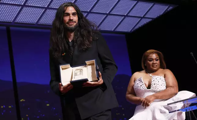 Director Oliver Laxe, left, accepts the jury prize for 'Sirat', presented by Da'Vine Joy Randolph, right, during the awards ceremony of the 78th international film festival, Cannes, southern France, Saturday, May 24, 2025. (Photo by Joel C Ryan/Invision/AP)
