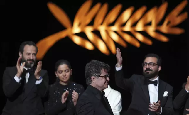 Director Jafar Panahi, front, accepts the Palme d'Or for the film 'It Was Just an Accident', during the awards ceremony of the 78th international film festival, Cannes, southern France, Saturday, May 24, 2025. (Photo by Lewis Joly/Invision/AP)