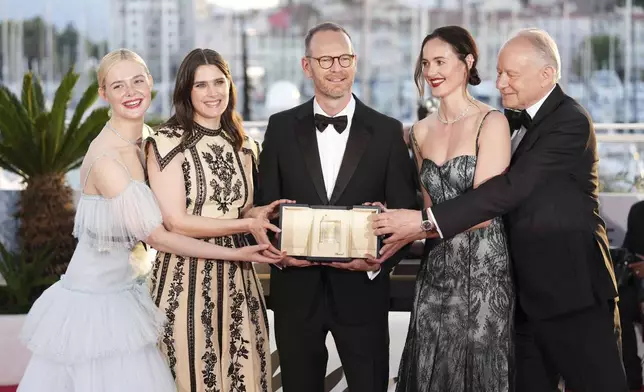 Director Joachim Trier, centre, winner of the grand prix for the film 'Sentimental Value', poses with Elle Fanning, from left, Inga Ibsdotter Lilleaas, Renate Reinsve and Stellan Skarsgard at the awards ceremony photo call at the 78th international film festival, Cannes, southern France, Saturday, May 24, 2025. (Photo by Scott A Garfitt/Invision/AP)