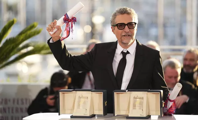Director Kleber Mendonca Filho poses with his award for best director for the film 'The Secret Agent' as well as the best actor award received on behalf of Wagner Moura at the awards ceremony photo call at the 78th international film festival, Cannes, southern France, Saturday, May 24, 2025. (Photo by Scott A Garfitt/Invision/AP)