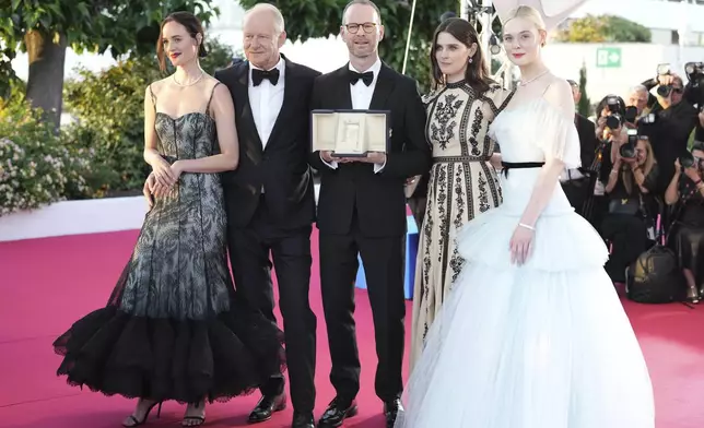 Director Joachim Trier, centre, winner of the grand prix for the film 'Sentimental Value', poses with Renate Reinsve, from left, Stellan Skarsgard, Inga Ibsdotter Lilleaas and Elle Fanning at the awards ceremony photo call at the 78th international film festival, Cannes, southern France, Saturday, May 24, 2025. (AP Photo/Natacha Pisarenko)