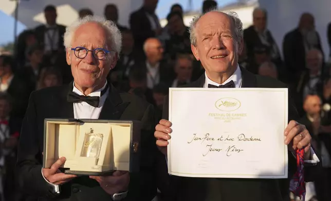 Directors Jean-Pierre Dardenne, left, and Luc Dardenne, winners of award for best screenplay for 'Jeunes Meres,' pose for photographers at the awards ceremony photo call at the 78th international film festival, Cannes, southern France, Saturday, May 24, 2025. (AP Photo/Natacha Pisarenko)