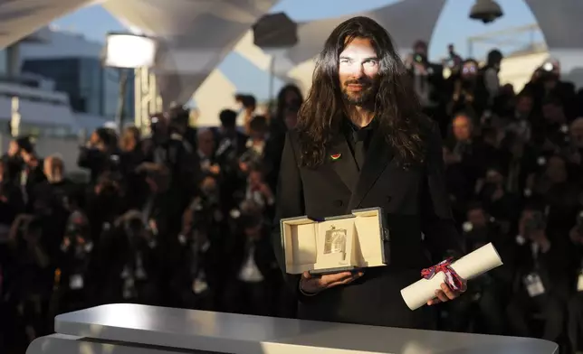 Director Oliver Laxe, winner of the jury prize for 'Sirat', poses for photographers at the awards ceremony photo call at the 78th international film festival, Cannes, southern France, Saturday, May 24, 2025. (AP Photo/Natacha Pisarenko)