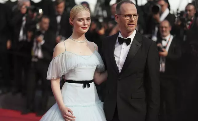 Elle Fanning, left, and Joachim Trier pose for photographers during the awards ceremony red carpet at the 78th international film festival, Cannes, southern France, Saturday, May 24, 2025. (AP Photo/Natacha Pisarenko)