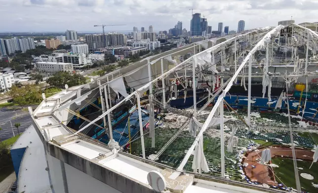 FILE - The roof of the Tropicana Field is damaged the morning after Hurricane Milton hit the region Oct. 10, 2024, in St. Petersburg, Fla. (AP Photo/Julio Cortez, File)
