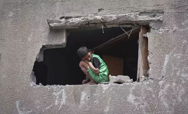 A boy looks as Palestinians search the rubble of a house targeted by an Israeli army strike that killed at least five people in Khan Younis, in the southern Gaza Strip, on Thursday, May 1, 2025. (AP Photo/Abdel Kareem Hana)