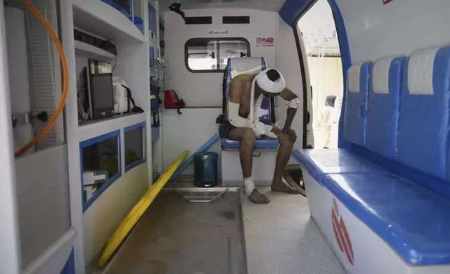 A wounded man sits inside an ambulance at the Nasser hospital after an Israeli army strike hit a house killing at least five members of the Abu Sahloul family, in Khan Younis, in the southern Gaza Strip, Thursday, May 1, 2025. (AP Photo/Abdel Kareem Hana)