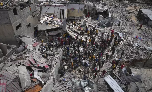 Palestinians search the rubble of a house targeted by an Israeli army strike that killed at least five people in Khan Younis, in the southern Gaza Strip, on Thursday, May 1, 2025. (AP Photo/Abdel Kareem Hana)