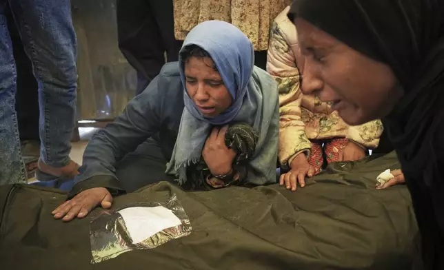 Islam Abu Sahloul mourns the death of her sister Lamia, 32, who was killed when an Israeli army strike hit a house killing at least five members of the Abu Sahloul family, in Khan Younis, in the southern Gaza Strip, Thursday, May 1, 2025. (AP Photo/Abdel Kareem Hana)