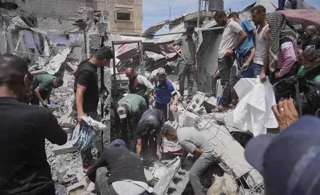 Palestinians search the rubble of a house targeted by an Israeli army strike that killed at least five people in Khan Younis, in the southern Gaza Strip, on Thursday, May 1, 2025. (AP Photo/Abdel Kareem Hana)
