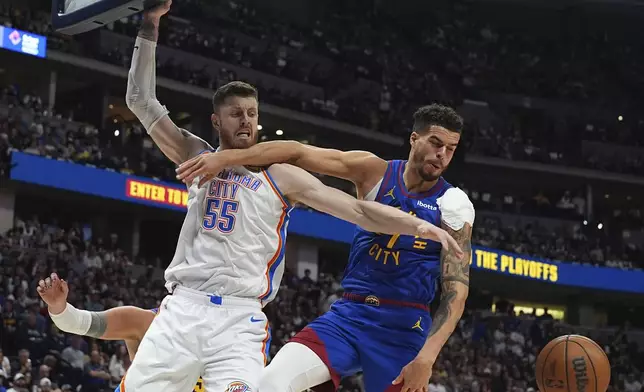 Oklahoma City Thunder center Isaiah Hartenstein, left, fights for control of a loose ball with Denver Nuggets forward Michael Porter Jr. in the second half of Game 3 in the Western Conference semifinals of the NBA basketball playoffs Friday, May 9, 2025, in Denver. (AP Photo/David Zalubowski)
