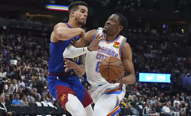 Oklahoma City Thunder forward Jalen Williams, right, drives to the basket as Denver Nuggets forward Michael Porter Jr. defends in the second half of Game 3 in the Western Conference semifinals of the NBA basketball playoffs Friday, May 9, 2025, in Denver. (AP Photo/David Zalubowski)