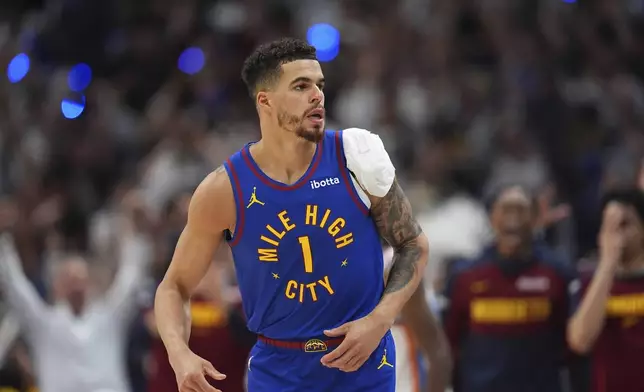 Denver Nuggets forward Michael Porter Jr. reacts after hitting a 3-point basket against the Oklahoma City Thunder in overtime of Game 3 in the Western Conference semifinals of the NBA basketball playoffs Friday, May 9, 2025, in Denver. (AP Photo/David Zalubowski)