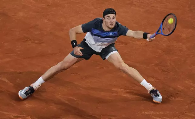 Jack Draper, of Britain, returns the ball against Lorenzo Musetti, of Italy, during the men's semifinal at the Madrid Open tennis tournament in Madrid, Spain, Friday, May 2, 2025. (AP Photo/Manu Fernandez)