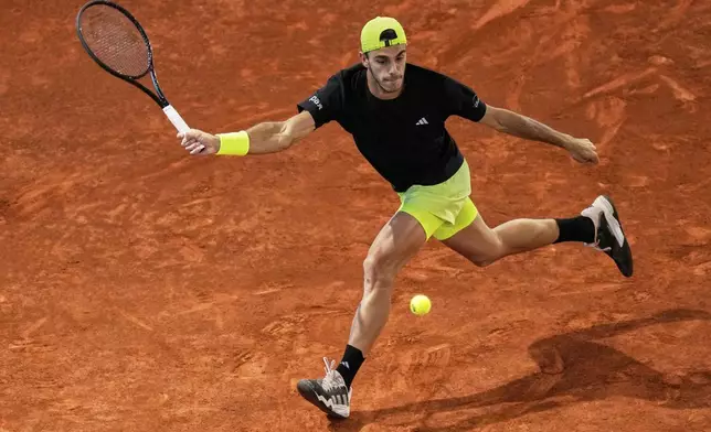 Francisco Cerundolo from Argentina returns the ball against Casper Ruud of Norway during men's semifinal at the Madrid Open tennis tournament in Madrid, Spain, Friday, May 2, 2025. (AP Photo/Manu Fernandez)