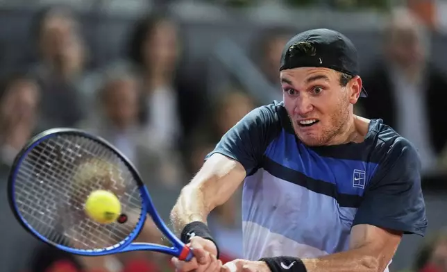 Jack Draper of Great Britain returns the ball against Lorenzo Musetti of Italy during men's semifinal at the Madrid Open tennis tournament in Madrid, Spain, Friday, May 2, 2025. (AP Photo/Manu Fernandez)