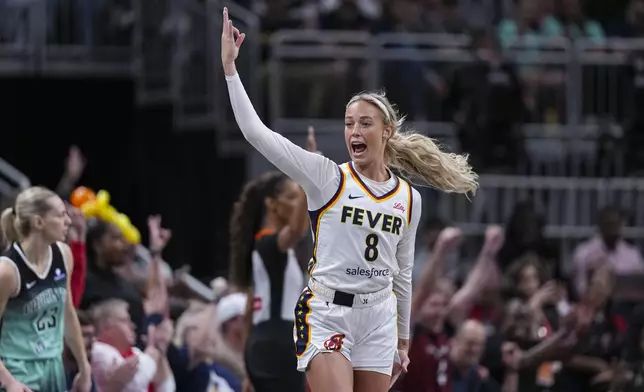 Indiana Fever guard Sophie Cunningham (8) celebrates after a three-point basket against the New York Liberty in the first half of a WNBA basketball game in Indianapolis, Saturday, May 24, 2025. (AP Photo/Michael Conroy)
