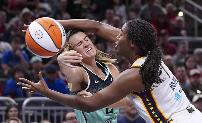 New York Liberty guard Sabrina Ionescu (20) is fouled by Indiana Fever forward Aliyah Boston (7) in the first half of a WNBA basketball game in Indianapolis, Saturday, May 24, 2025. (AP Photo/Michael Conroy)