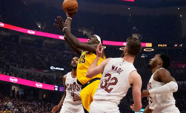 Indiana Pacers forward Pascal Siakam (43) goes to the basket between Cleveland Cavaliers forward Evan Mobley, left, forward Dean Wade (32) and guard Donovan Mitchell, right, in the first half during Game 1 in the Eastern Conference semifinals of the NBA basketball playoffs Sunday, May 4, 2025, in Cleveland. (AP Photo/Sue Ogrocki)