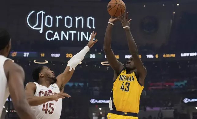 Indiana Pacers forward Pascal Siakam (43) shoots over Cleveland Cavaliers' Donovan Mitchell (45) in the first half during Game 1 in the Eastern Conference semifinals of the NBA basketball playoffs Sunday, May 4, 2025, in Cleveland. (AP Photo/Sue Ogrocki)