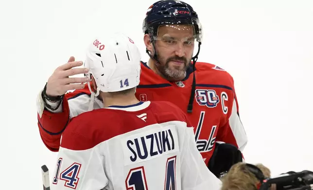 Washington Capitals left wing Alex Ovechkin (8) greets Montreal Canadiens center Nick Suzuki (14) after Game 5 of a first-round NHL hockey playoff series Wednesday, April 30, 2025, in Washington. (AP Photo/Nick Wass)
