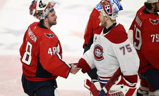 Washington Capitals goaltender Logan Thompson (48) shakes hands with Montreal Canadiens goaltender Jakub Dobes (75) after Game 5 of a first-round NHL hockey playoff series Wednesday, April 30, 2025, in Washington. (AP Photo/Nick Wass)