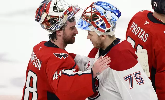 Washington Capitals goaltender Logan Thompson (48) greets Montreal Canadiens goaltender Jakub Dobes (75) after Game 5 of a first-round NHL hockey playoff series Wednesday, April 30, 2025, in Washington. (AP Photo/Nick Wass)