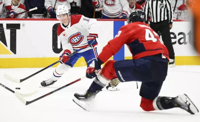 Montreal Canadiens right wing Cole Caufield (13) skates with the puck against Washington Capitals right wing Tom Wilson (43) in the second period of Game 5 of a first-round NHL hockey playoff series Wednesday, April 30, 2025, in Washington. (AP Photo/Nick Wass)