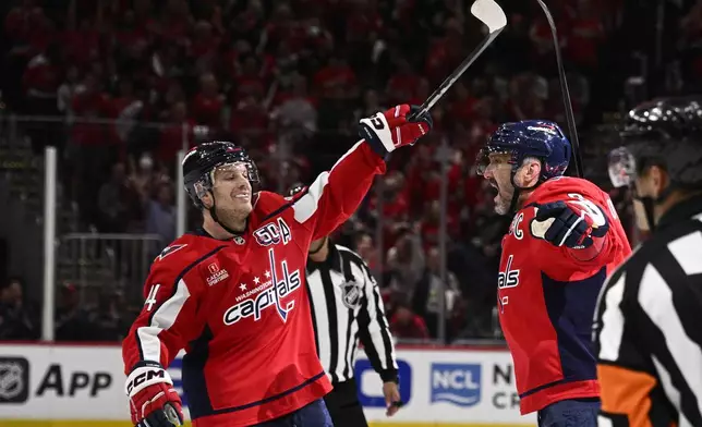 Washington Capitals left wing Alex Ovechkin (8), right, celebrates his goal with defenseman John Carlson, left, in the first period of Game 5 of a first-round NHL hockey playoff series against the Montreal Canadiens, Wednesday, April 30, 2025, in Washington. (AP Photo/Nick Wass)
