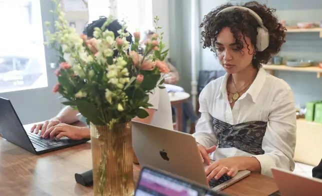 Summer Dean, 27, works inside a coffee shop, Friday, May 23, 2025, in New York. (AP Photo/Heather Khalifa)