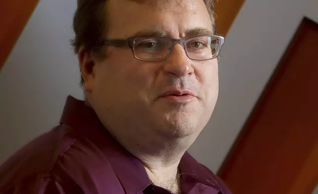 FILE - LinkedIn co-founder Reid Hoffman sits in the lobby of LinkedIn's Mountain View, Calif., headquarters on Tuesday, May 7, 2013. (AP Photo/Noah Berger, File)