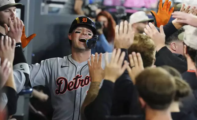 Detroit Tigers' Spencer Torkelson (20) is greeted in the dugout by teammates after hitting a solo home run during the second inning of a baseball against the Toronto Blue Jays in Toronto, Saturday, May 17, 2025. (Chris Young/The Canadian Press via AP)