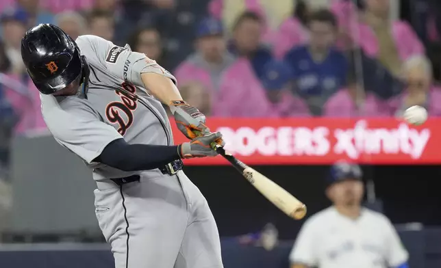 Detroit Tigers first base Spencer Torkelson (20) hits a solo home run during the second inning of a baseball game against the Toronto Blue Jays in Toronto, Saturday, May 17, 2025. (Chris Young/The Canadian Press via AP)