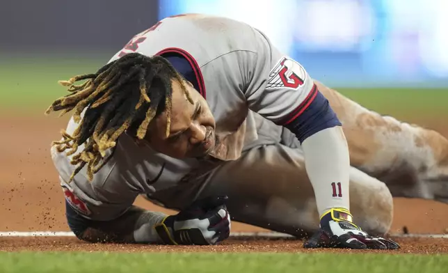 Cleveland Guardians' Jose Ramirez falls after reaching first base on a single against the Toronto Blue Jays during the third inning of a baseball game in Toronto on Friday, May 2, 2025. (Chris Young/The Canadian Press via AP)