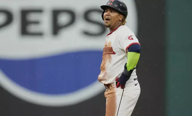 Cleveland Guardians' Jose Ramirez reacts after stealing second base, his 250th career steal, in the 10th inning of a baseball game against the Minnesota Twins in Cleveland, Thursday, May 1, 2025. (AP Photo/Sue Ogrocki)