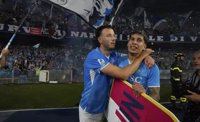 Napoli's players celebrate after winning the Italian league soccer title at the end of the Italian Serie A soccer match between Napoli and Cagliari at the Diego Maradona stadium in Naples, Italy, Friday, May 23, 2025. (AP Photo/Gregorio Borgia)