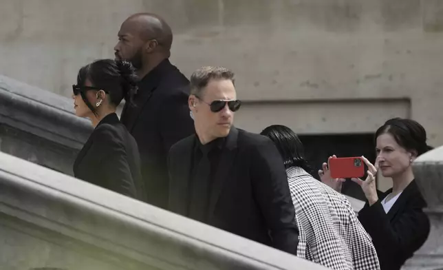 Kim Kardashian, left, arrives to testify regarding a robbery of millions of dollars in jewels from her Paris hotel room in 2016, in Paris, Tuesday, May 13, 2025. (AP Photo/Aurelien Morissard)