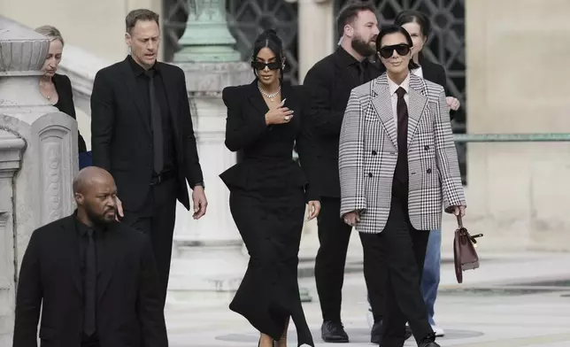 Kim Kardashian, center, accompanied by her mother Kris Jenner, right, leaves the justice palace after testifying, regarding a robbery of millions of dollars in jewels from her Paris hotel room in 2016, in Paris, Tuesday, May 13, 2025. (AP Photo/Aurelien Morissard)