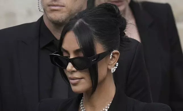 Kim Kardashian, center, leaves the justice palace after testifying regarding a robbery of millions of dollars in jewels from her Paris hotel room in 2016, in Paris, Tuesday, May 13, 2025. (AP Photo/Aurelien Morissard)