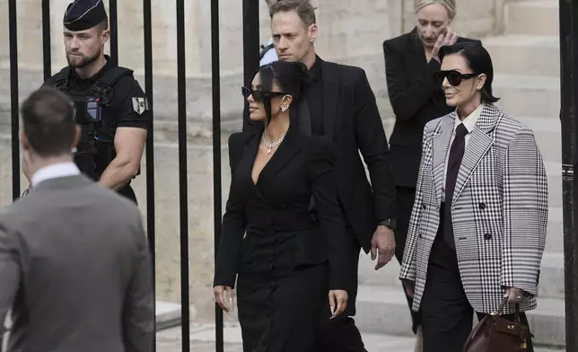 Kim Kardashian, center, accompanied by her mother Kris Jenner, right, leaves the justice palace after testifying, regarding a robbery of millions of dollars in jewels from her Paris hotel room in 2016, in Paris, Tuesday, May 13, 2025. (AP Photo/Aurelien Morissard)