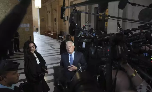 Michael Rhodes, lawyer for Kim Kardashian, speaks with the media at the justice palace after the testimony of his client regarding a robbery of millions of dollars in jewels from her Paris hotel room in 2016, in Paris, Tuesday, May 13, 2025. (AP Photo/Christophe Ena)
