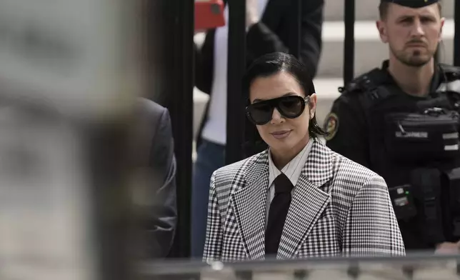 Kris Jenner, center, the mother of Kim Kardashian, arrives for a trial regarding a robbery of millions of dollars in jewels from Kim Kardashian's Paris hotel room in 2016, in Paris, Tuesday, May 13, 2025. (AP Photo/Aurelien Morissard)